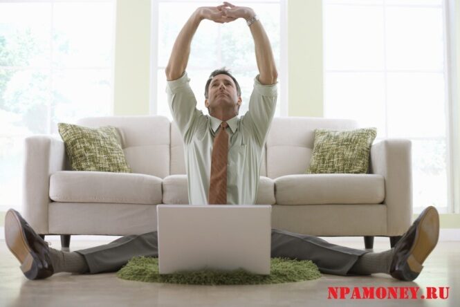 businessman-stretching-while-working-on-his-laptop